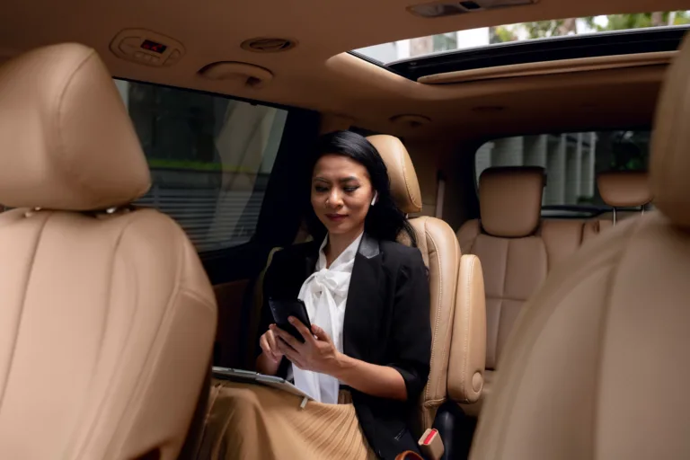 businesswoman-sitting-backseat-taxi (1)