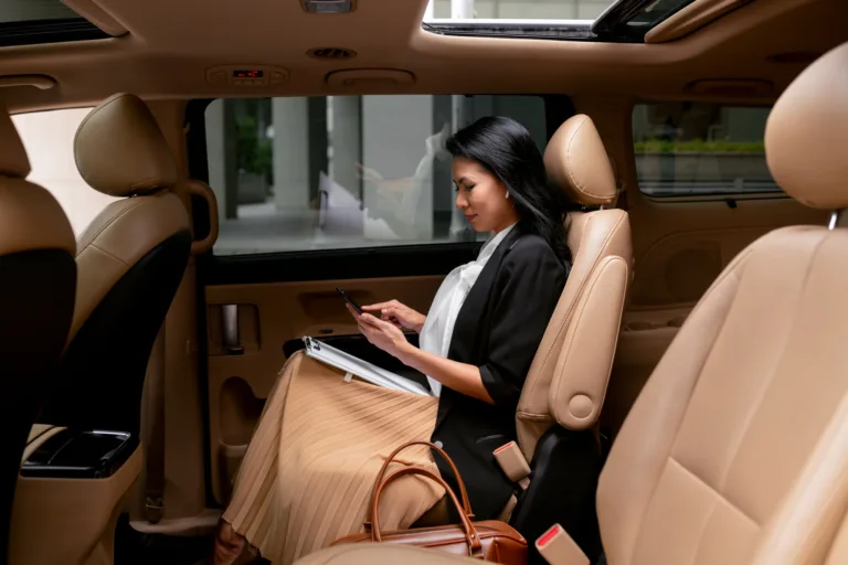 businesswoman-sitting-backseat-taxi